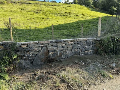 Field boundary dry stone wall repair after vehicle damage - insurance work