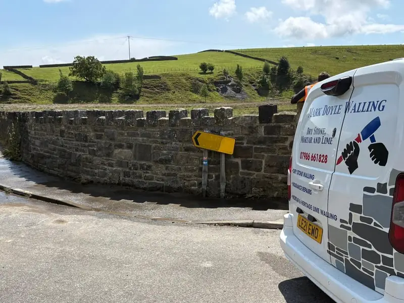 Traditional dry stone walling techniques in action