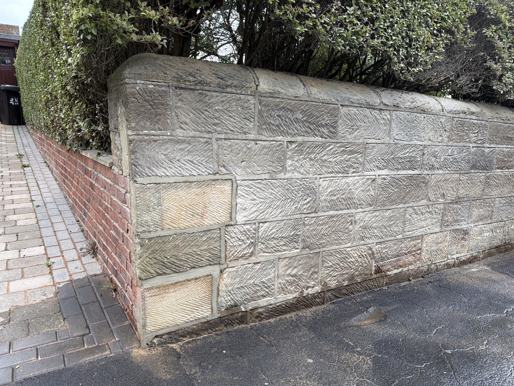 Completed insurance repair to the Whitby stone wall with herringbone punched finish